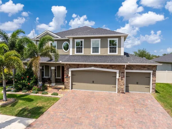 a front view of a house with a yard and garage