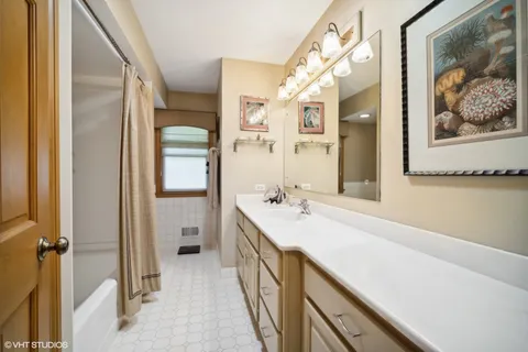 a bathroom with a double vanity sink and mirror