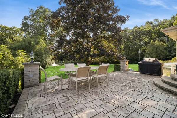 a view of a chairs and table in the back yard of the house