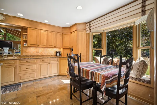 a dining room with furniture and window
