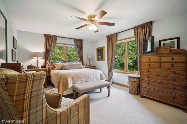 a spacious bedroom with a bed and a table