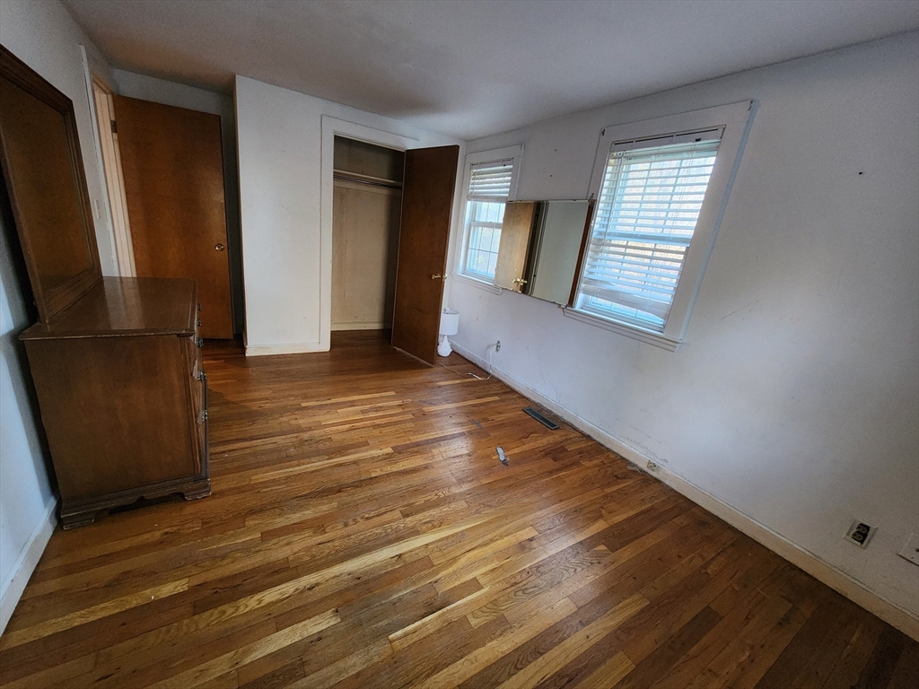68 Hudson Road Stow, MA 01775 - Photo 15 of 39 a view of an empty room with wooden floor and a window