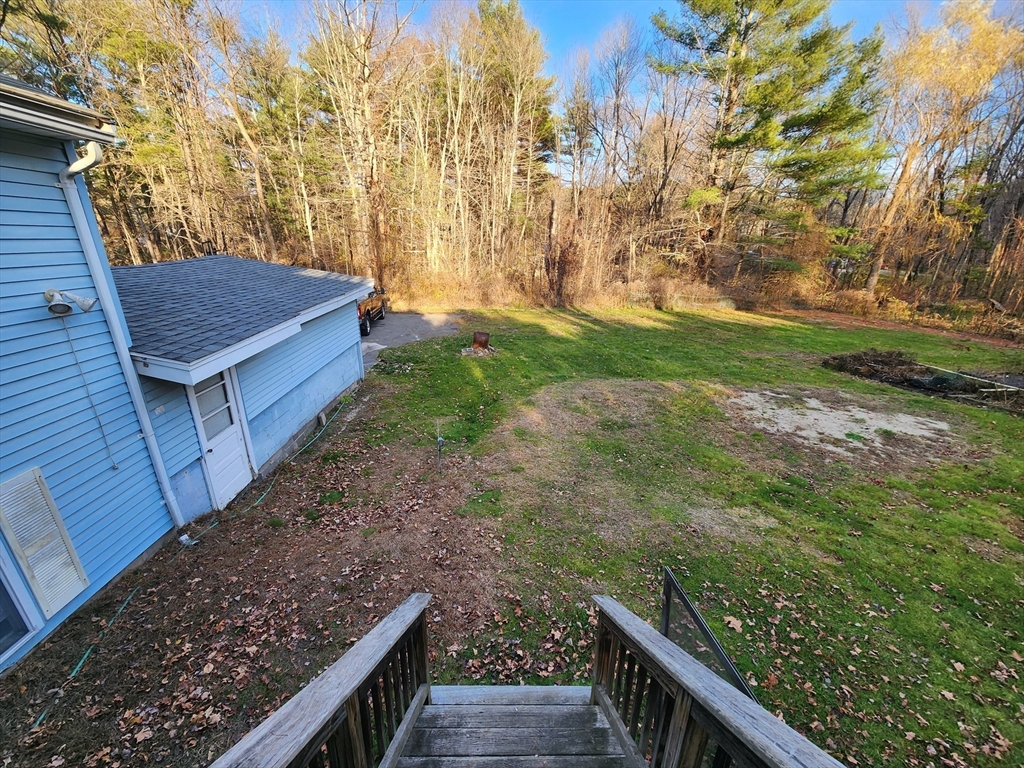 68 Hudson Road Stow, MA 01775 - Photo 24 of 39 a view of a backyard with wooden fence