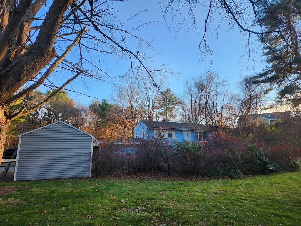 68 Hudson Road Stow, MA 01775 - Photo 35 of 39 a view of a backyard with potted plants and large trees