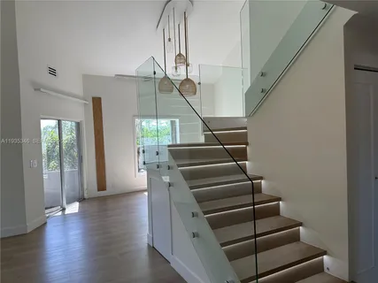 a living room with windows and flat screen tv