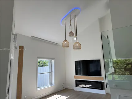 a large kitchen with a sink and dishwasher a refrigerator a sink dishwasher with wooden floor