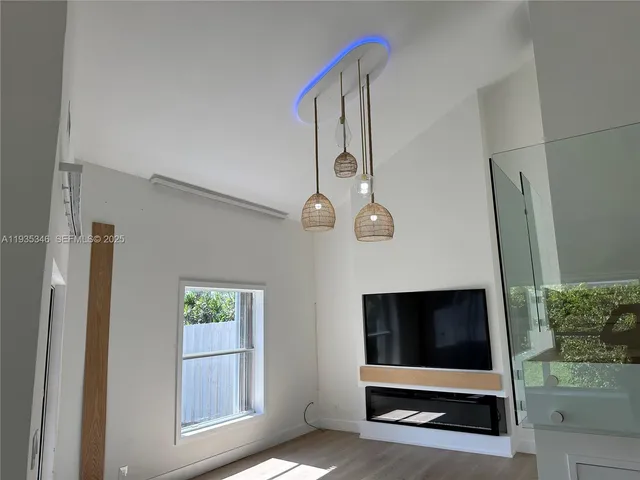 a large kitchen with a sink and dishwasher a refrigerator a sink dishwasher with wooden floor