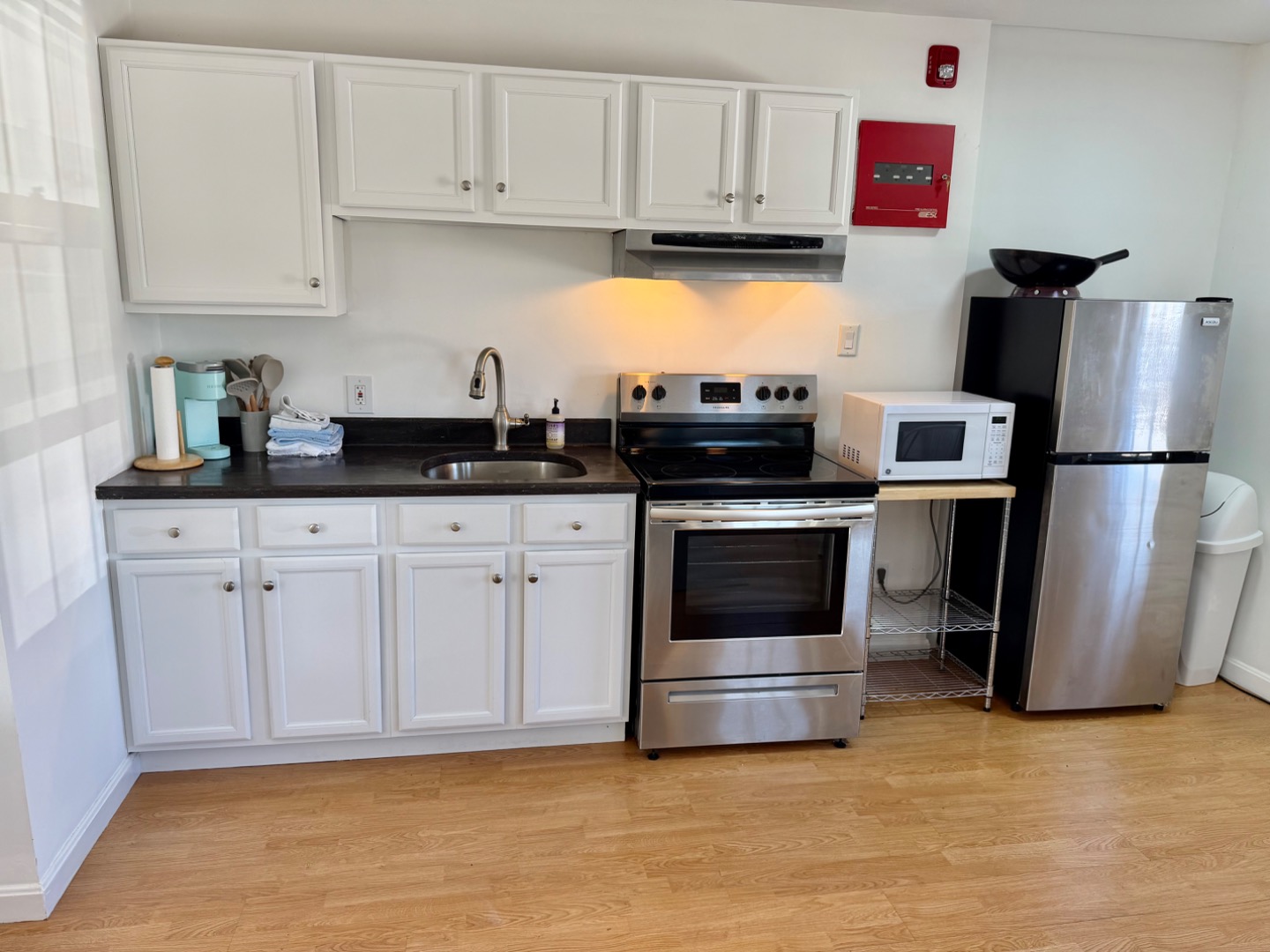 163 Orange Street Nantucket, MA 02554 - Photo 14 of 22 a kitchen with granite countertop a sink and stainless steel appliances