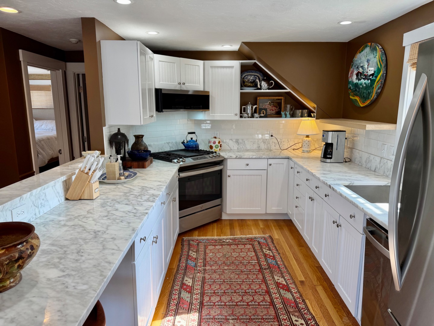 163 Orange Street Nantucket, MA 02554 - Photo 8 of 22 a kitchen with stainless steel appliances granite countertop a sink stove and refrigerator
