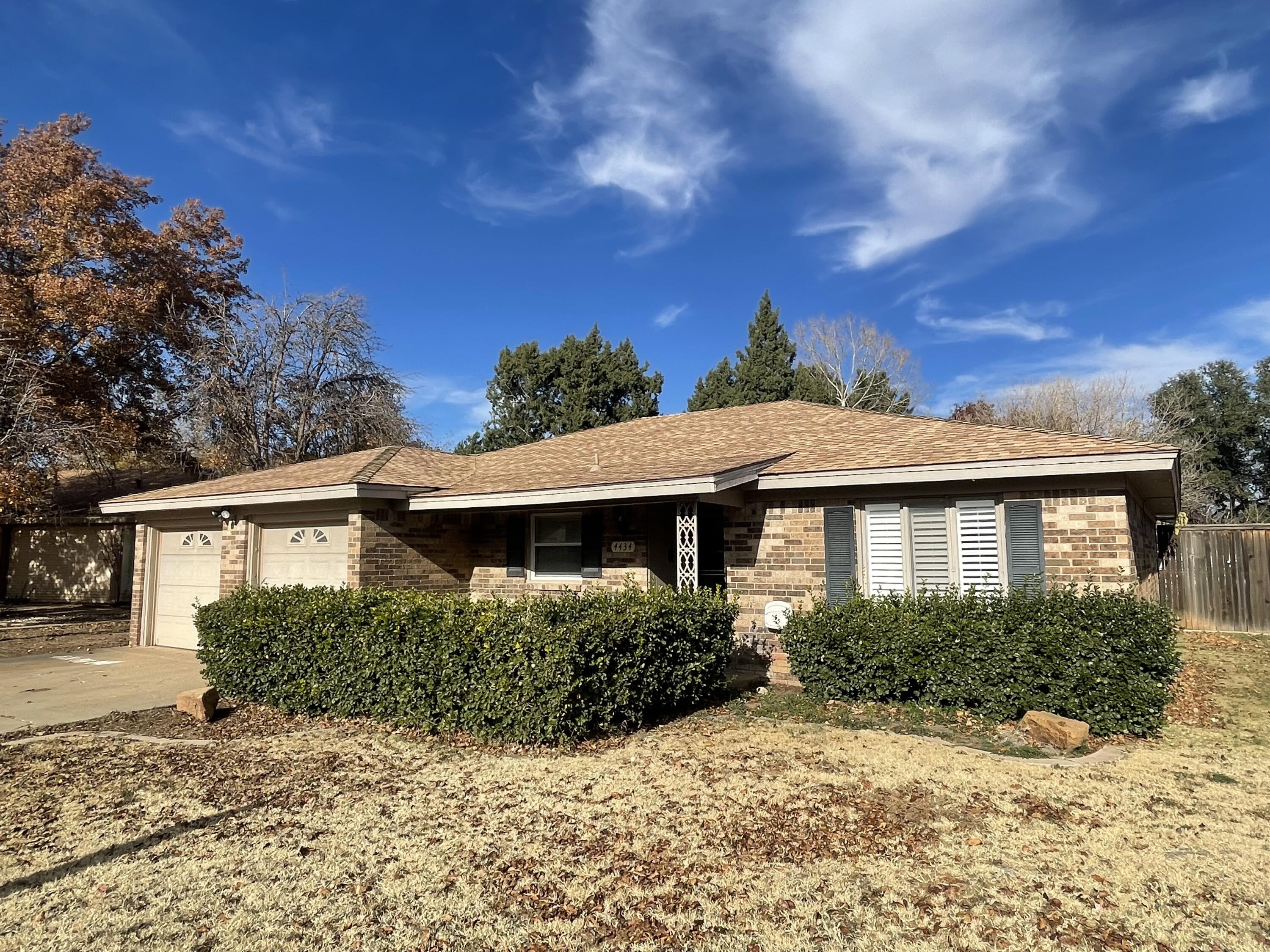4434 78th Street Lubbock, TX 79424 - Photo 1 of 11 a front view of a house with a yard