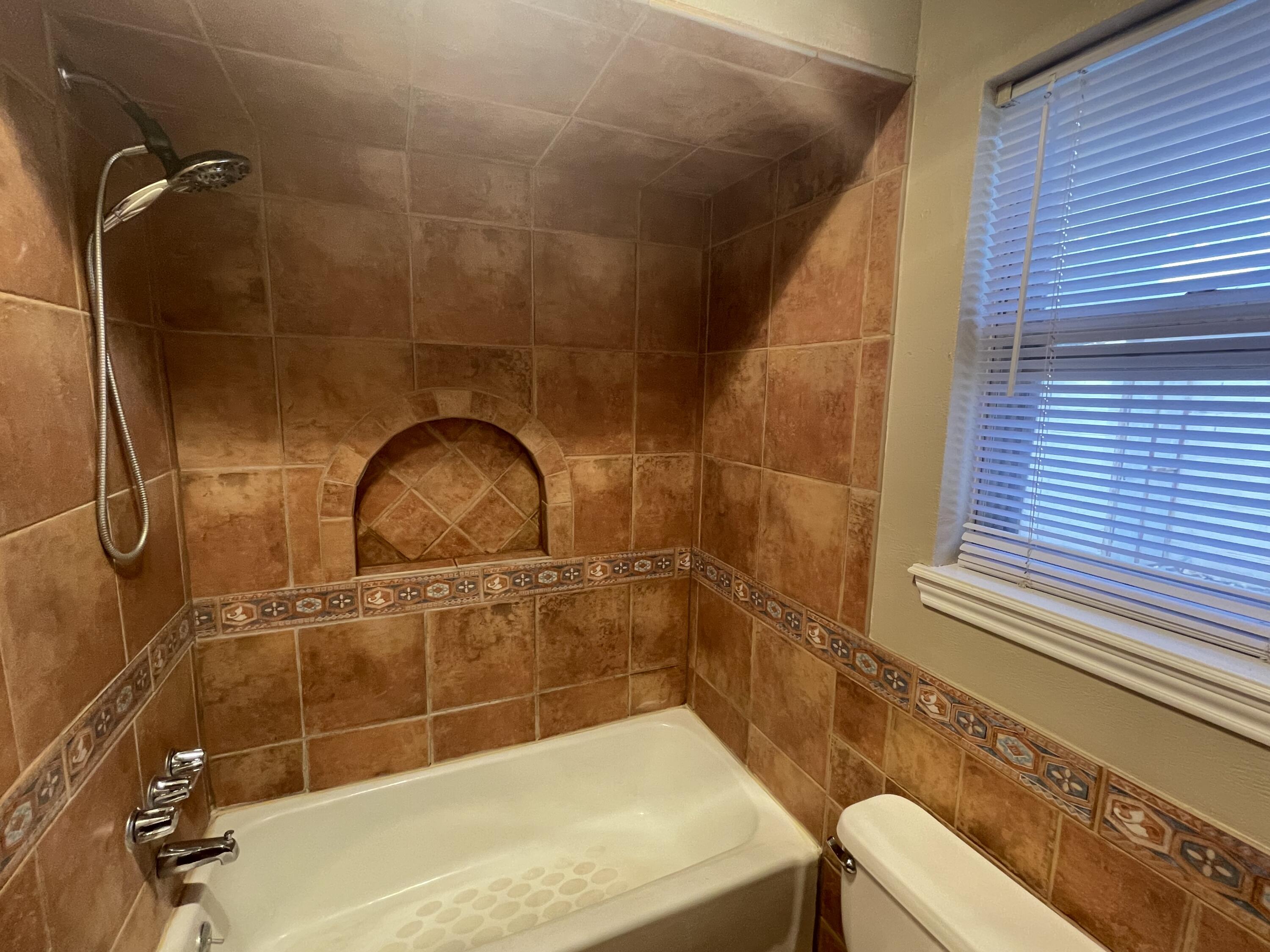 4434 78th Street Lubbock, TX 79424 - Photo 7 of 11 a bathroom with a sink and mirror
