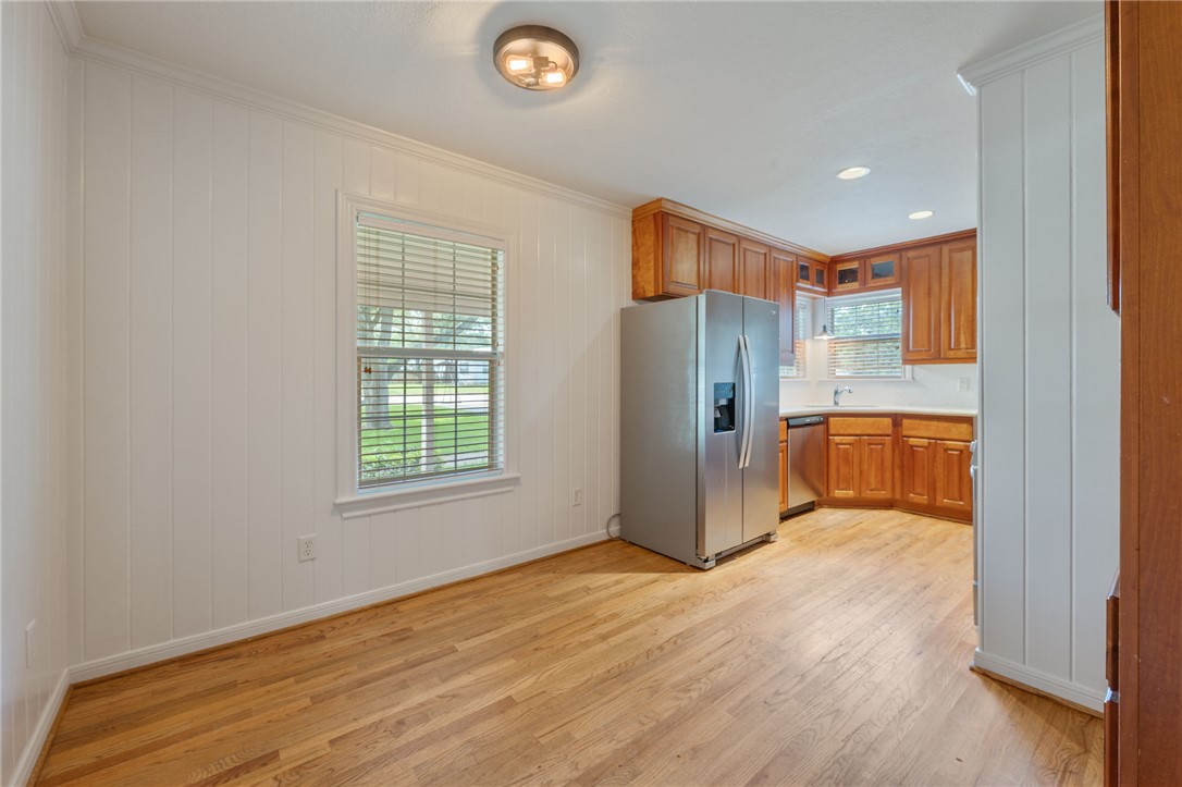 715 Inwood Drive Bryan, TX 77802 - Photo 25 of 34 a view of a kitchen with wooden floor and a window