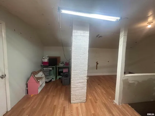a hallway with a wooden floor and a sink