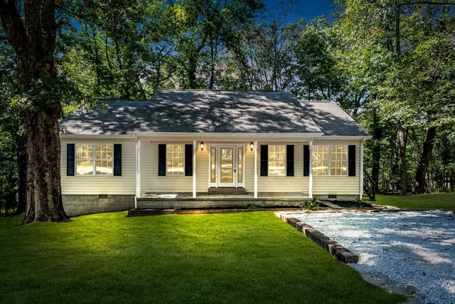 a front view of house with yard space and outdoor seating