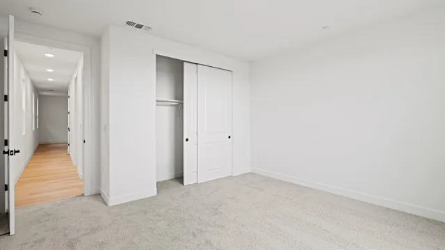 an empty room with a bathroom and a sink