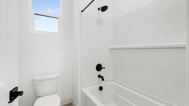 a bathroom with a toilet and a bathtub