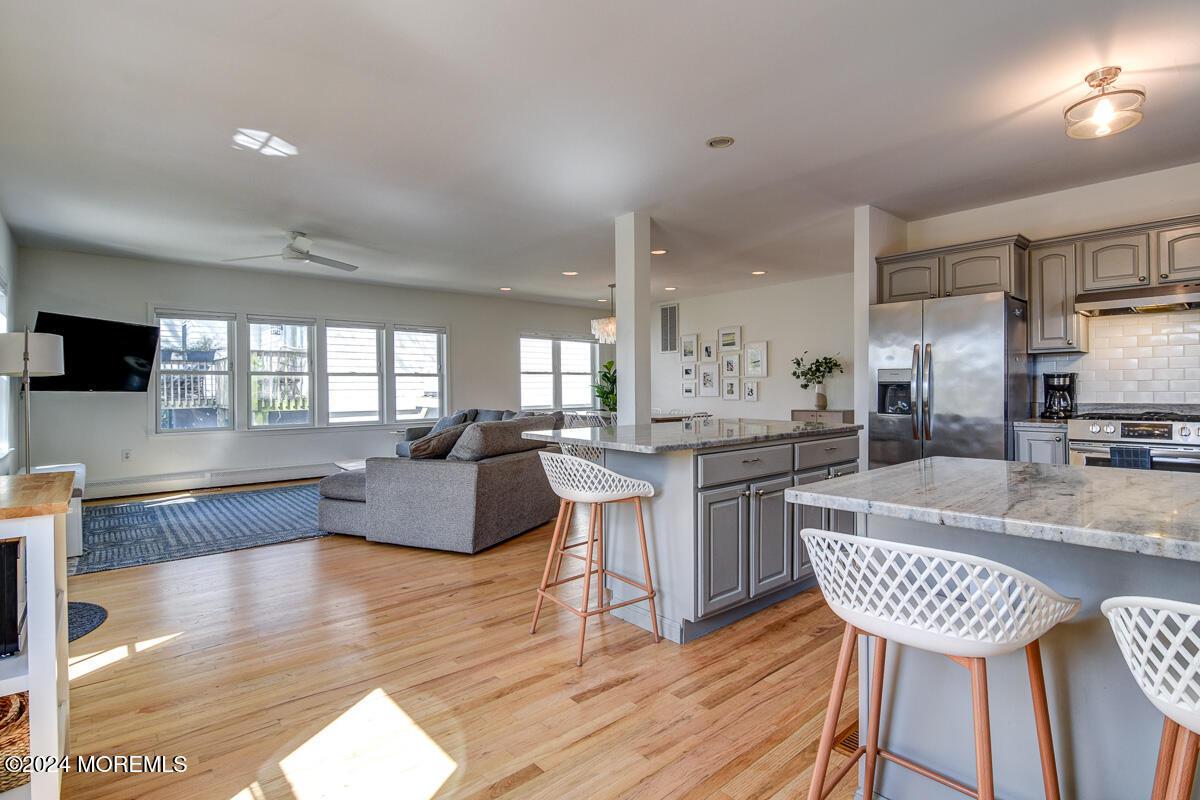212 Philadelphia Avenue Point Pleasant Beach, NJ 08742 - Photo 12 of 31 a living room with kitchen island furniture and a wooden floor