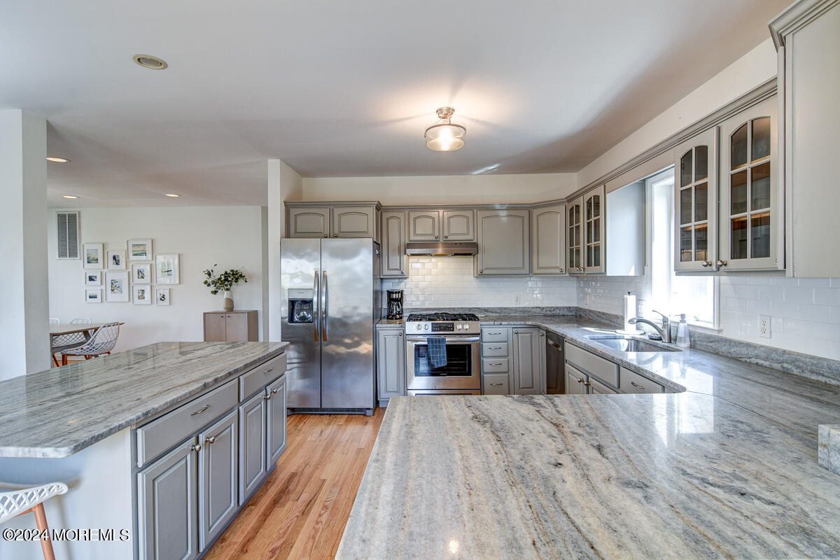 212 Philadelphia Avenue Point Pleasant Beach, NJ 08742 - Photo 13 of 31 a large kitchen with granite countertop a large counter top appliances and cabinets