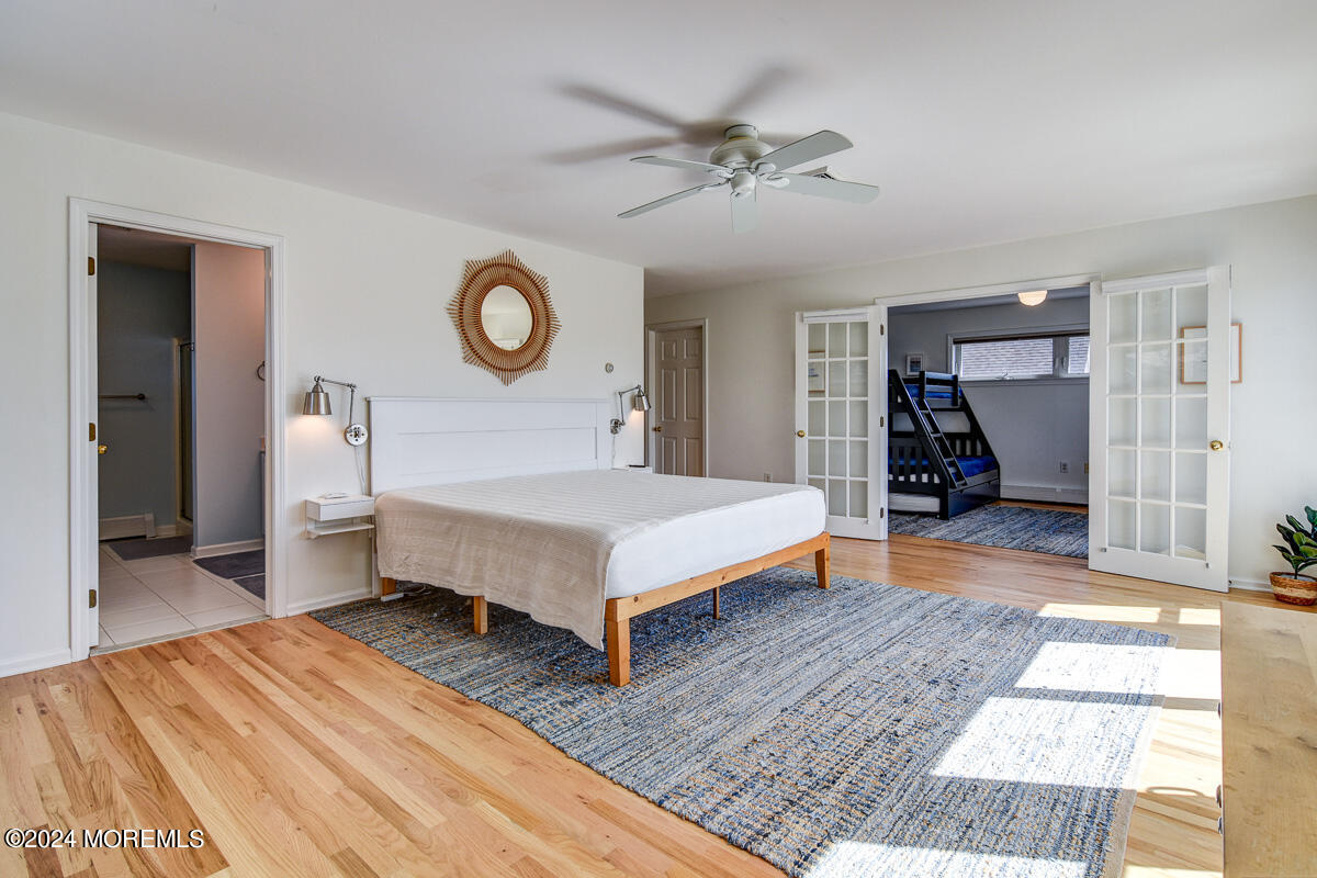 212 Philadelphia Avenue Point Pleasant Beach, NJ 08742 - Photo 19 of 31 a bedroom with a bed and a chandelier