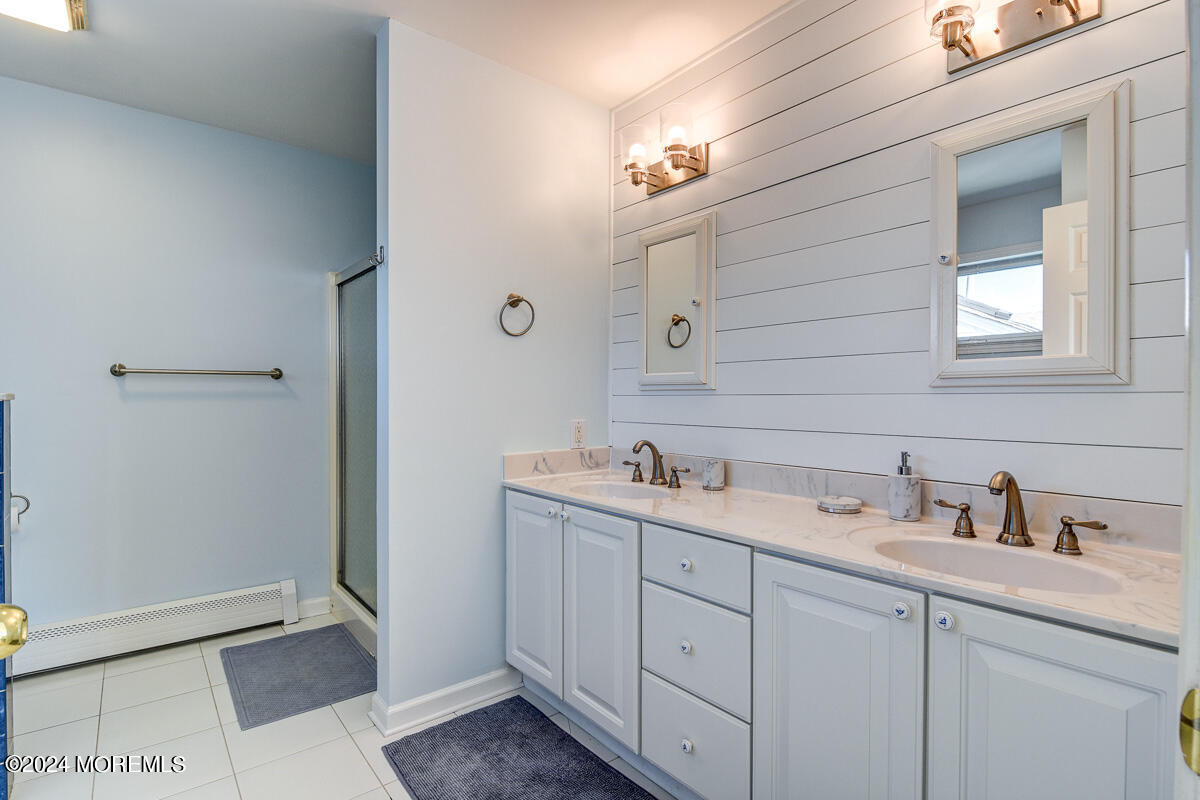 212 Philadelphia Avenue Point Pleasant Beach, NJ 08742 - Photo 20 of 31 a bathroom with a double vanity sink and mirror