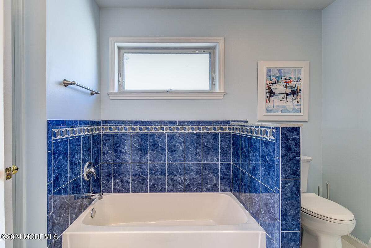 212 Philadelphia Avenue Point Pleasant Beach, NJ 08742 - Photo 22 of 31 a bath tub sitting next to a white toilet