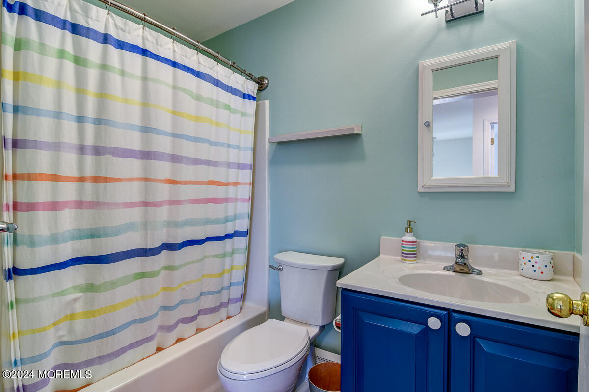 212 Philadelphia Avenue Point Pleasant Beach, NJ 08742 - Photo 27 of 31 a bathroom with a sink a toilet and shower curtain