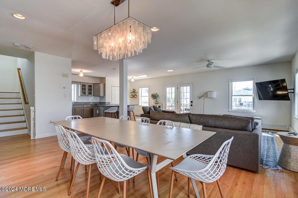 212 Philadelphia Avenue Point Pleasant Beach, NJ 08742 - Photo 8 of 31 a dining room with furniture a chandelier and wooden floor