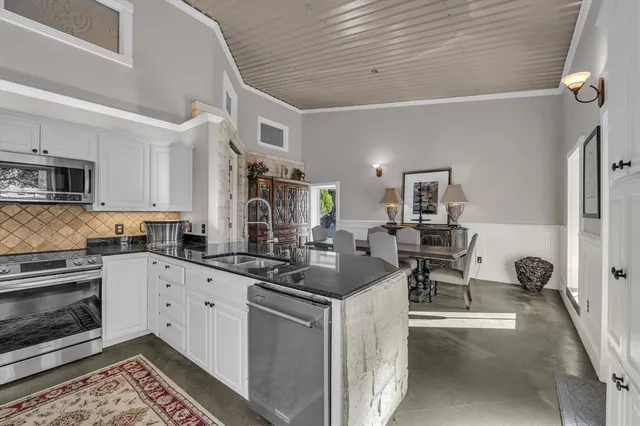 a bedroom with a large bed and a book shelf