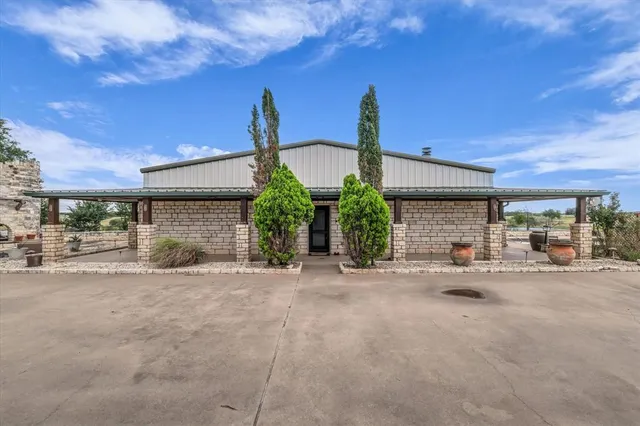 a front view of a house with basket ball court and a garage