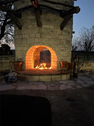 a view of a fountain in the backyard with potted plants