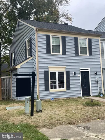 a house that has a tree in the yard