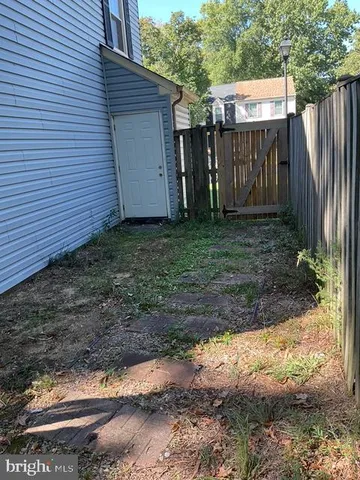 a view of house with backyard space and balcony