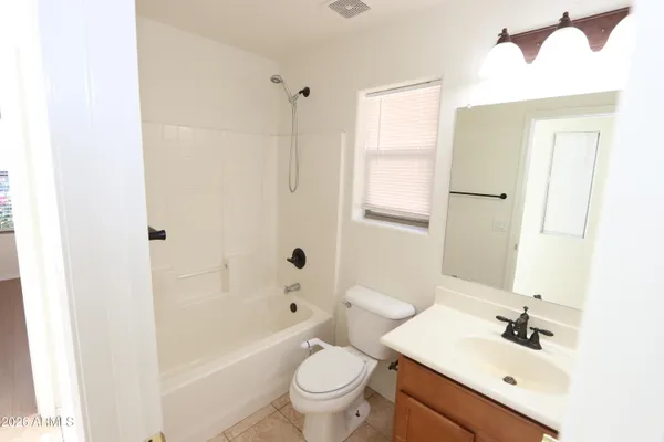 a view of a livingroom with a ceiling fan and window