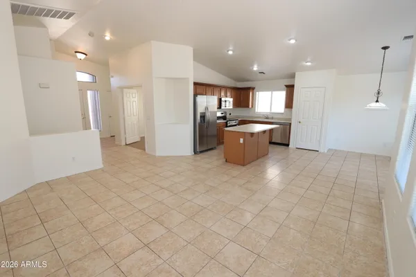 a kitchen with granite countertop a sink a counter top space and cabinets