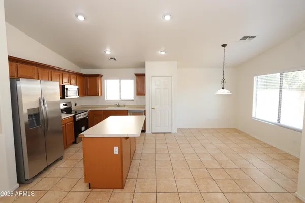 a large kitchen with a sink and white cabinets