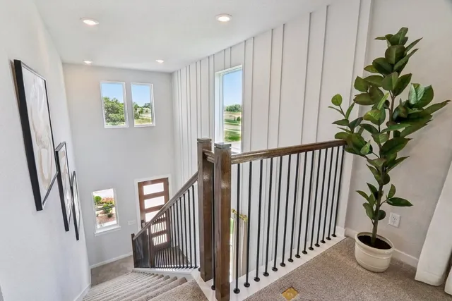 a view of a hallway with windows and stairs