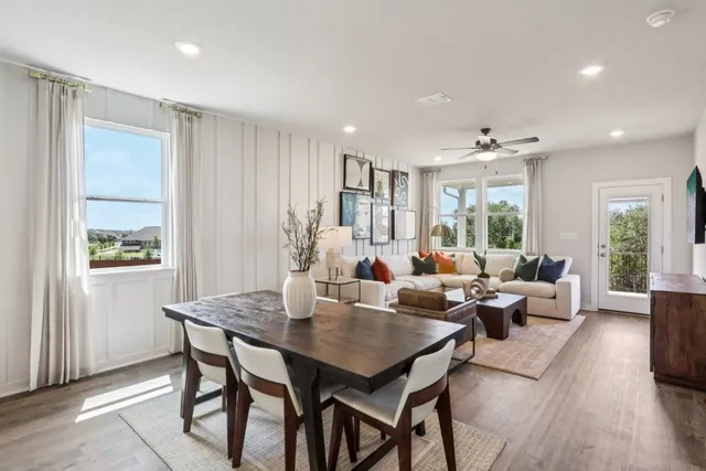 a living room with furniture potted plant and windows