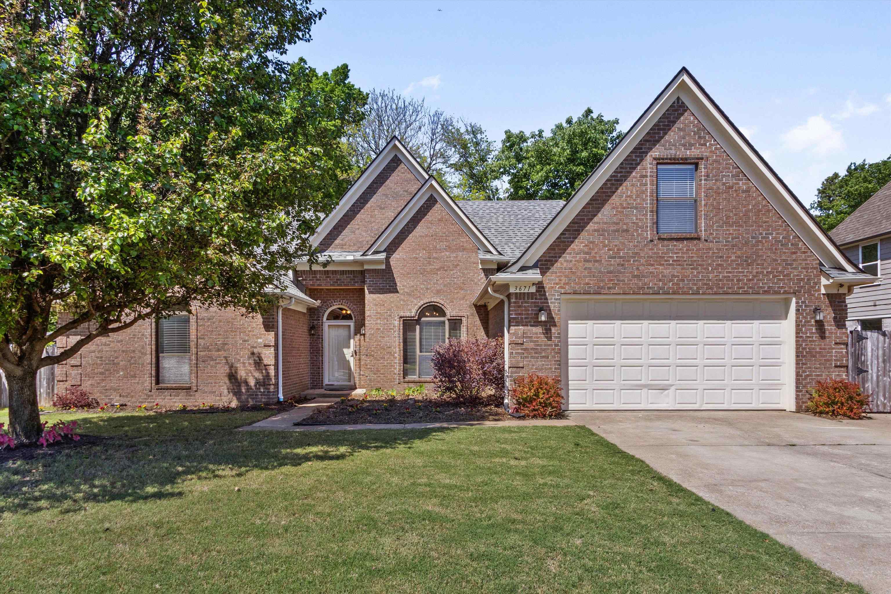 3671 Haynes Road Bartlett, TN 38133 - Photo 1 of 40 a front view of a house with a yard and garage
