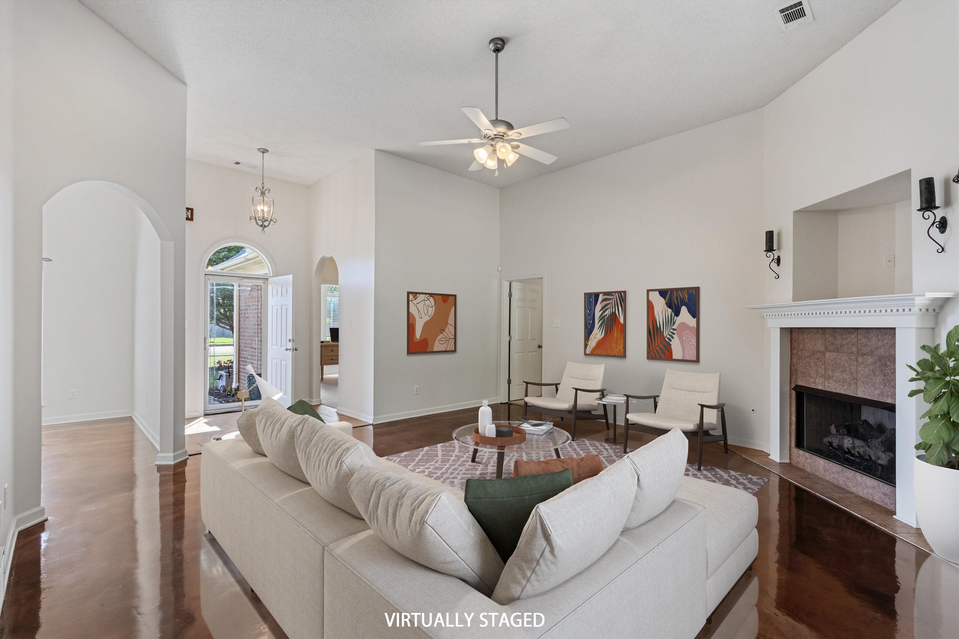 3671 Haynes Road Bartlett, TN 38133 - Photo 3 of 40 a living room with furniture a fireplace and a chandelier