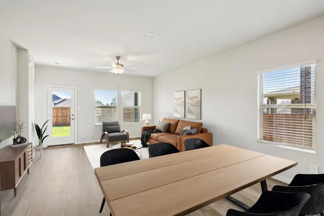 a bedroom with furniture and a large window