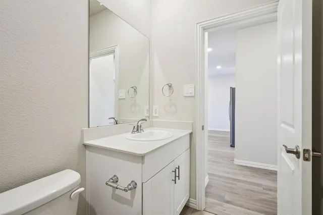 a spacious bathroom with a sink a toilet a shower and a mirror