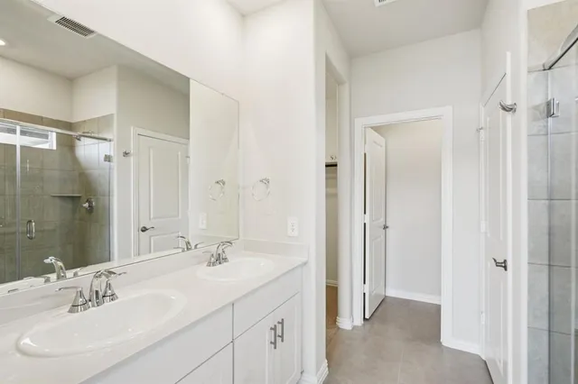 a bathroom with a double vanity sink mirror and double