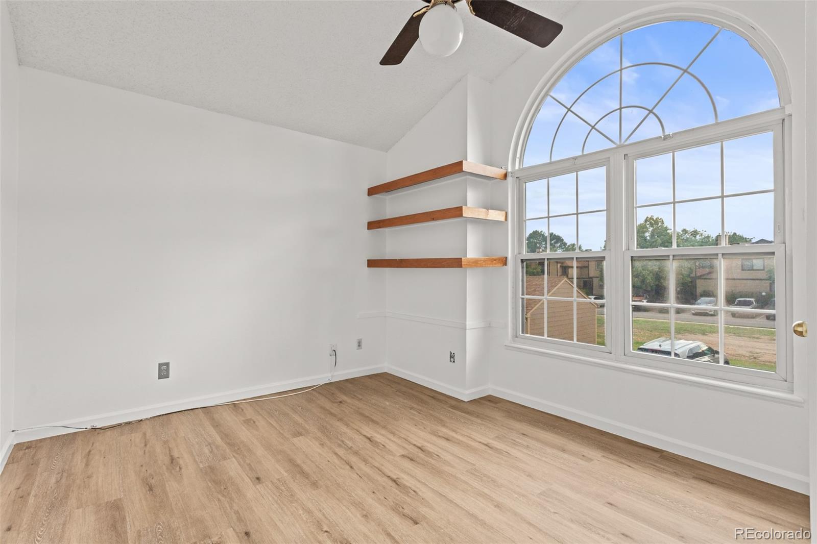 1720 South Quintero Way Aurora, CO 80017 - Photo 12 of 21 an empty room with wooden floor and windows