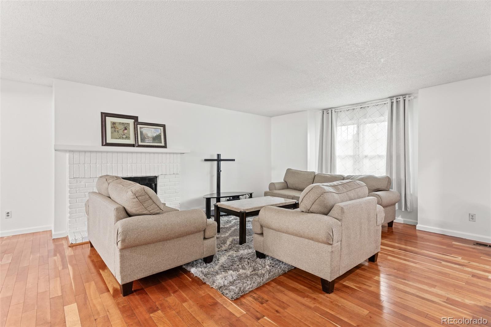 1720 South Quintero Way Aurora, CO 80017 - Photo 3 of 21 a living room with furniture and a couch