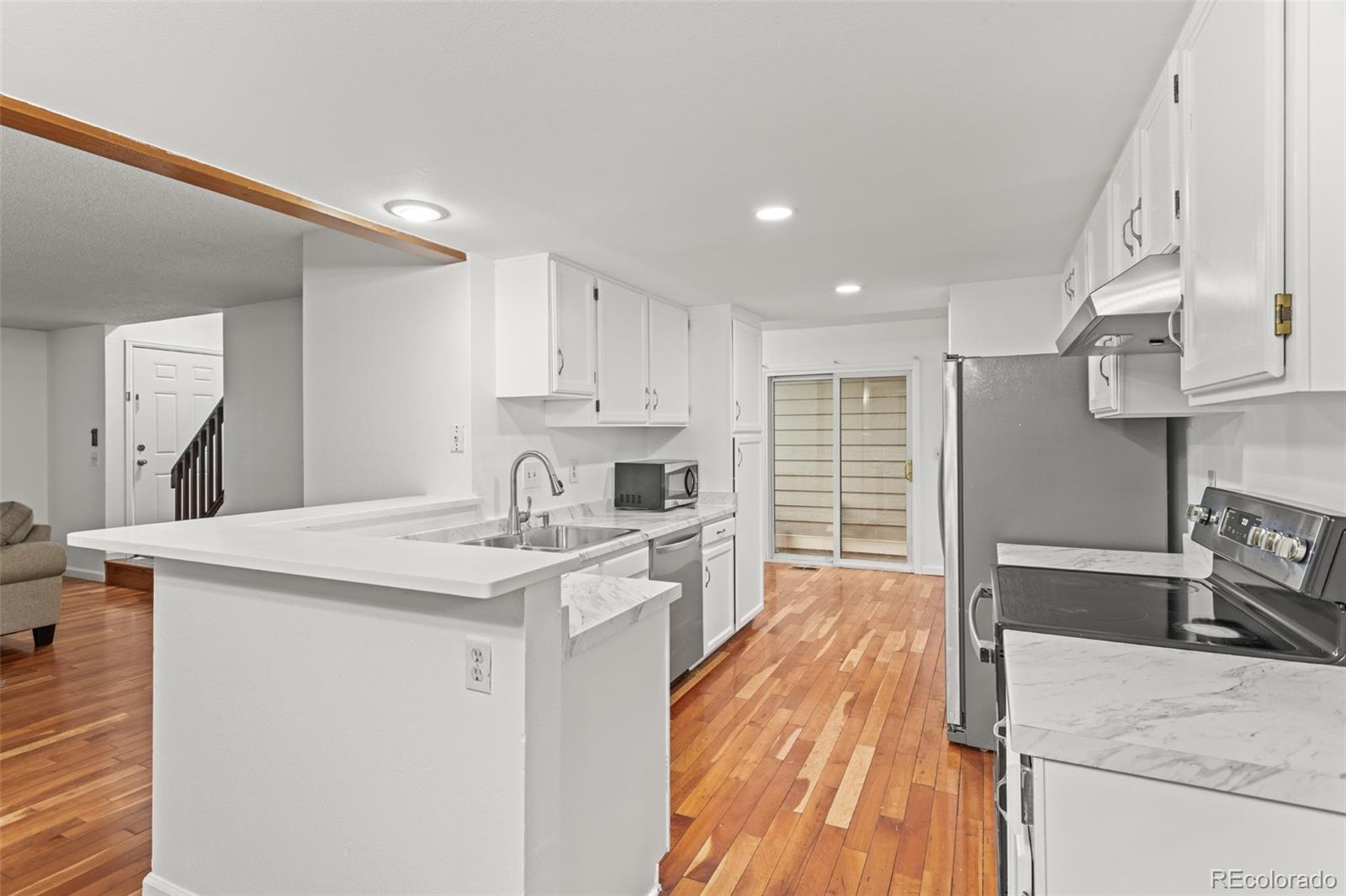 1720 South Quintero Way Aurora, CO 80017 - Photo 8 of 21 a kitchen with stainless steel appliances granite countertop a sink stove and refrigerator