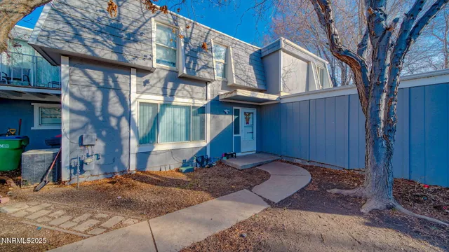 a view of a house with a wooden fence