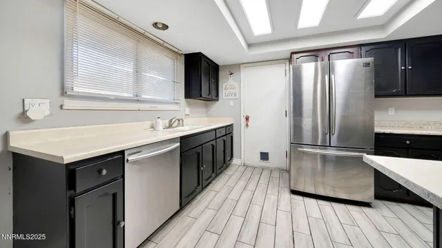 a kitchen with a sink appliances and cabinets