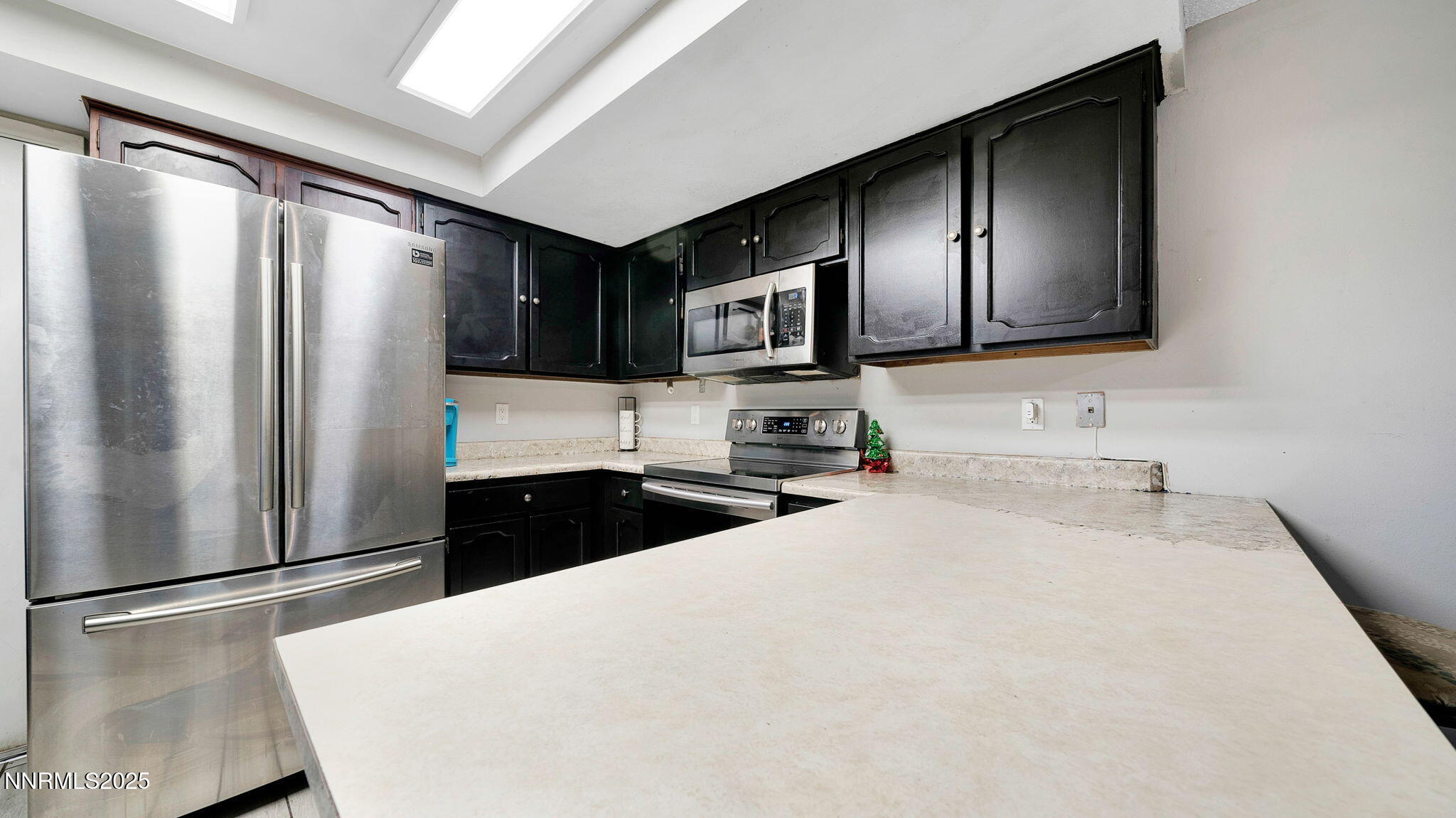7640 Bluestone Drive Reno, NV 89511 - Photo 15 of 30 a kitchen with stainless steel appliances a refrigerator sink and stove