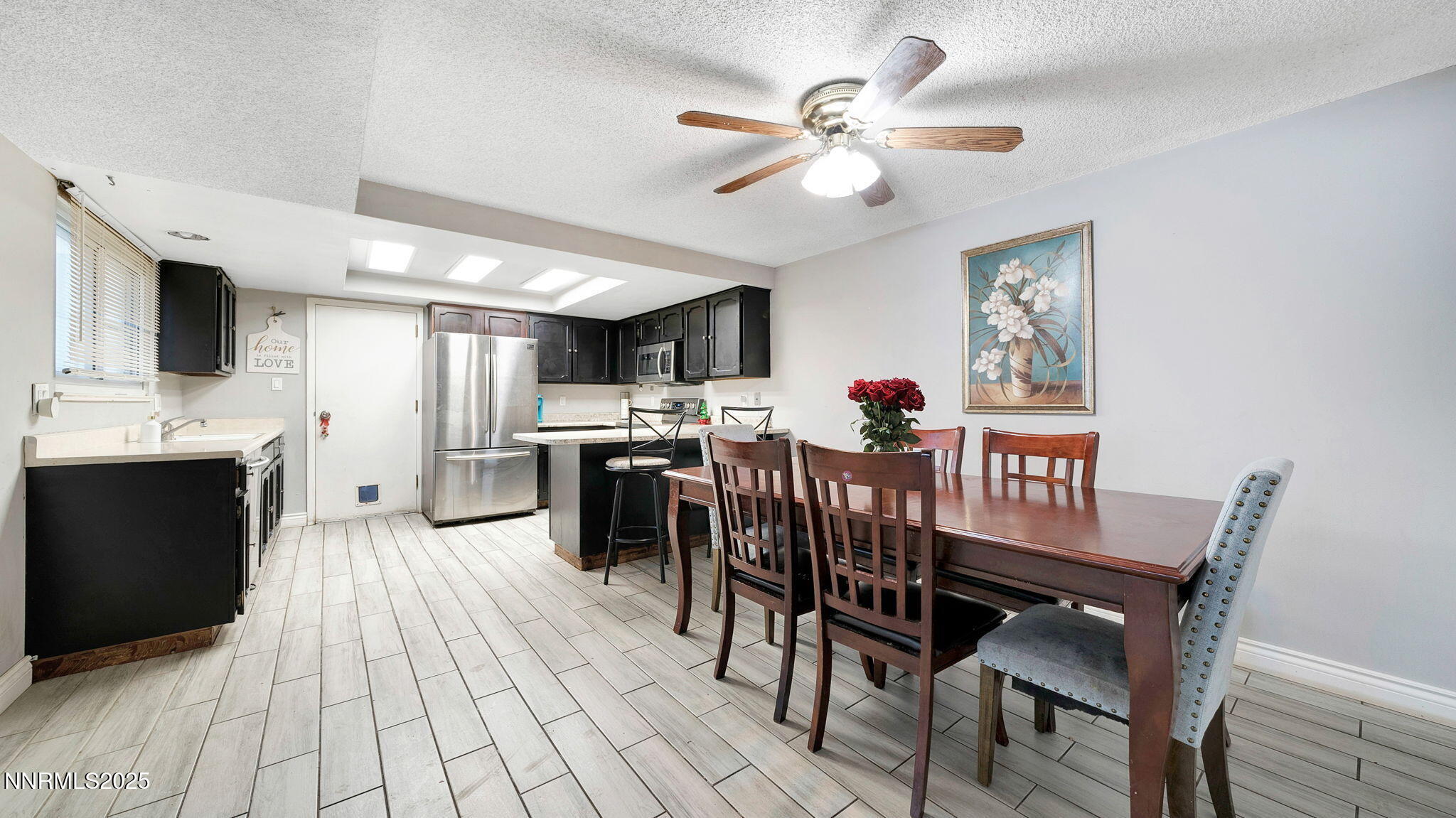 7640 Bluestone Drive Reno, NV 89511 - Photo 16 of 30 a view of a dining room with furniture and wooden floor