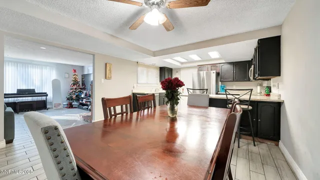 a dining room with furniture a kitchen view and a chandelier